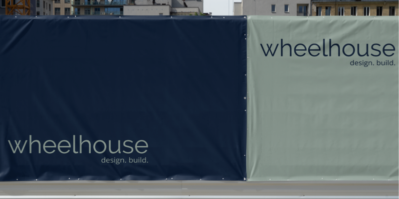 A construction side with wheelhouse design and build logo on it